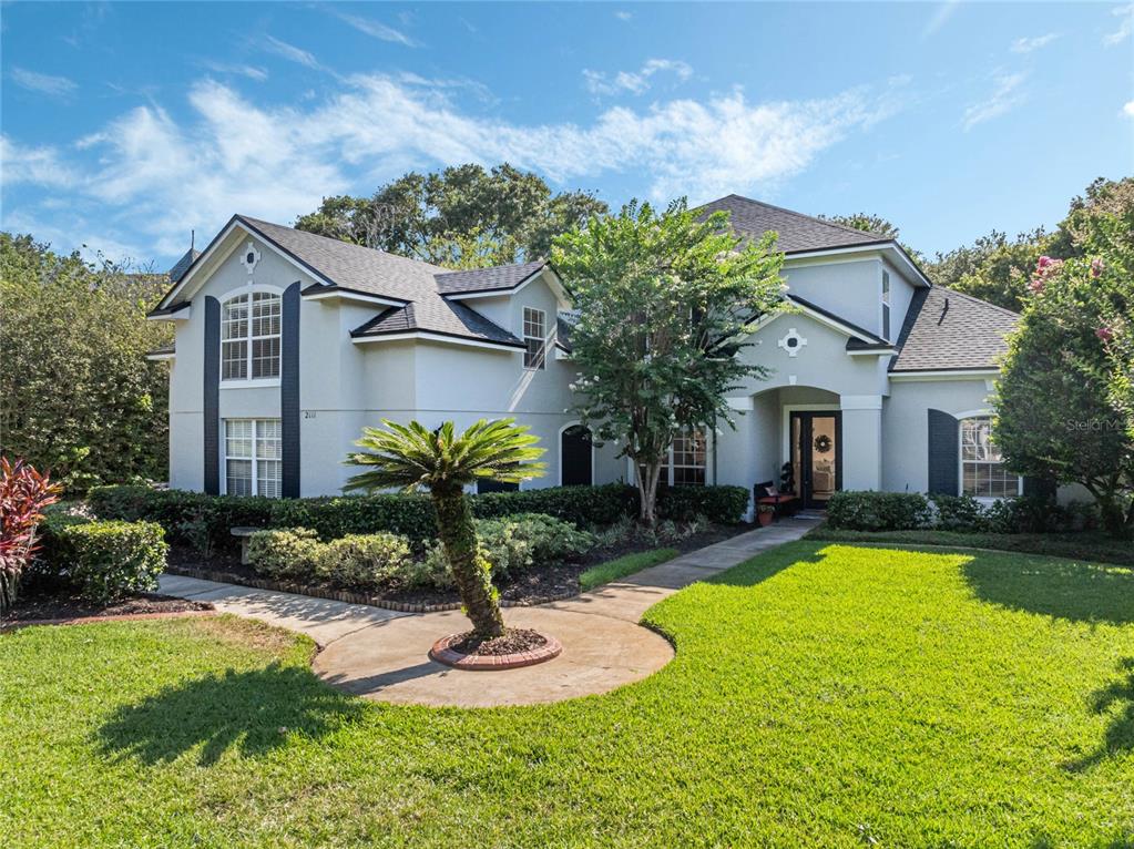 a front view of house with yard and green space