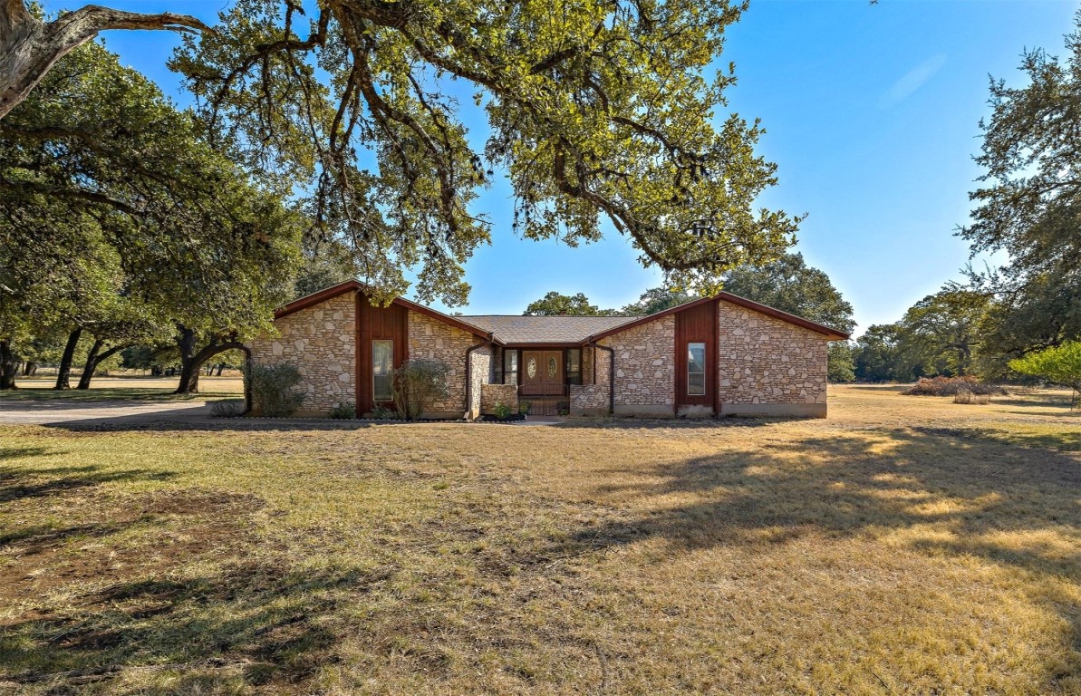 a front view of house with yard and trees