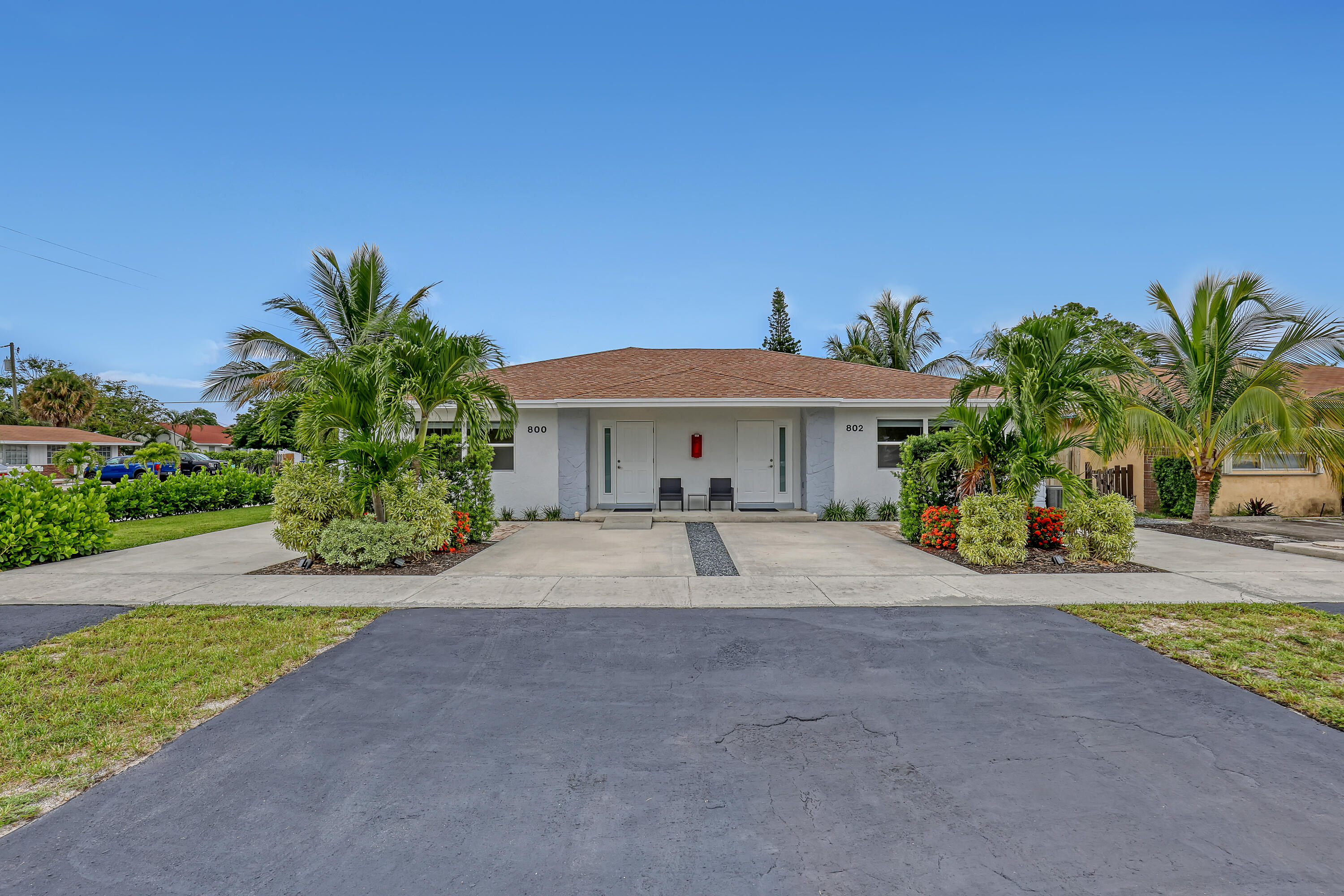 a front view of house with yard and car parked