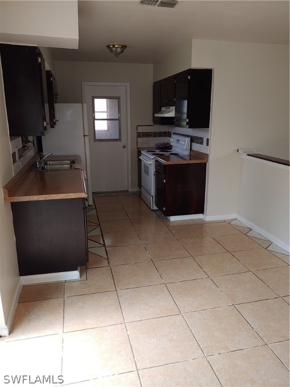 a room with a washing machine and a sink