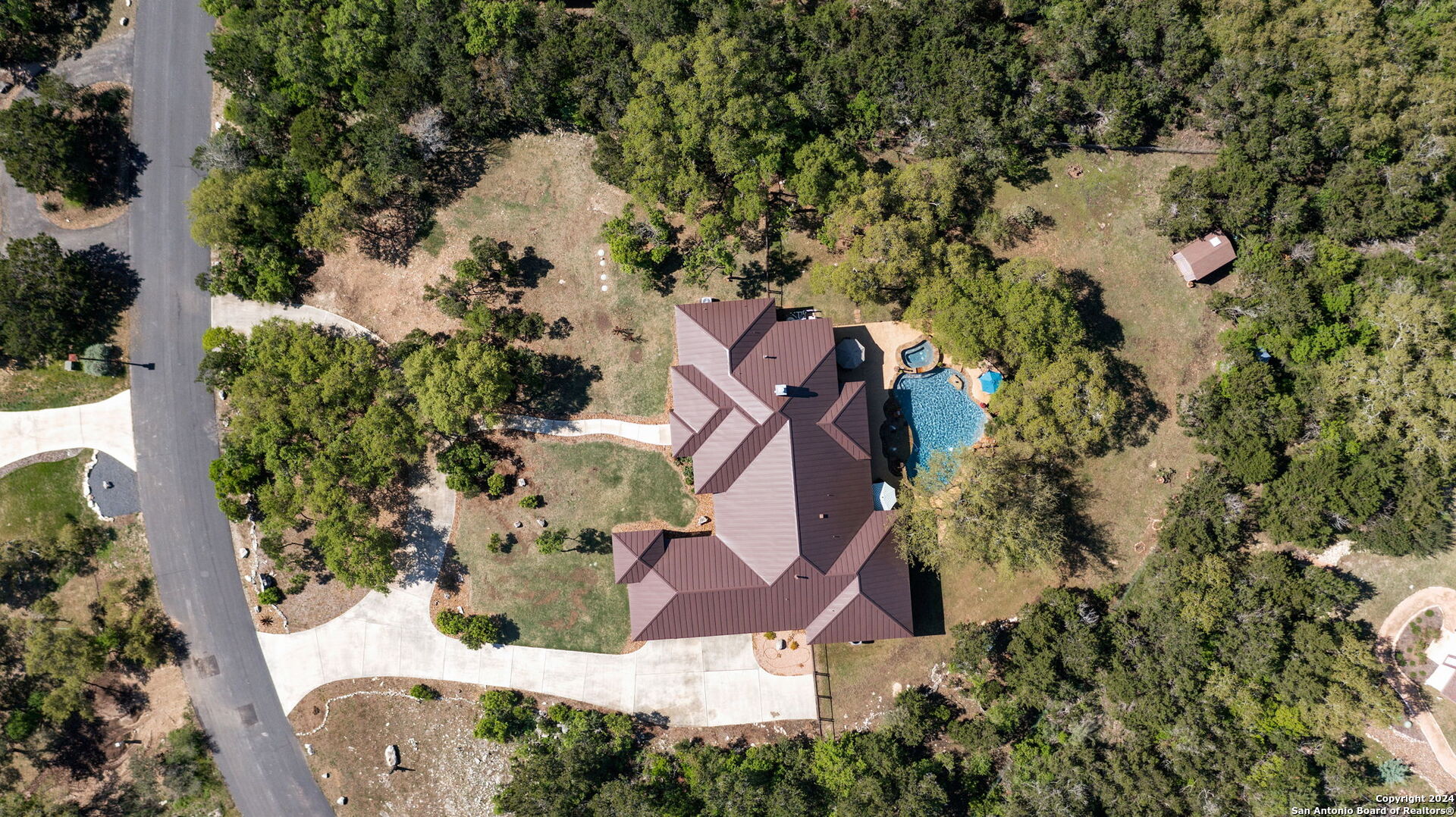 an aerial view of a house with a yard and garden