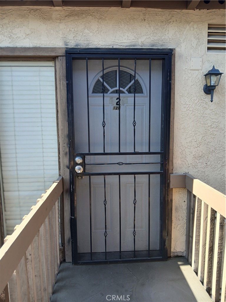 a view of a door and wooden floor