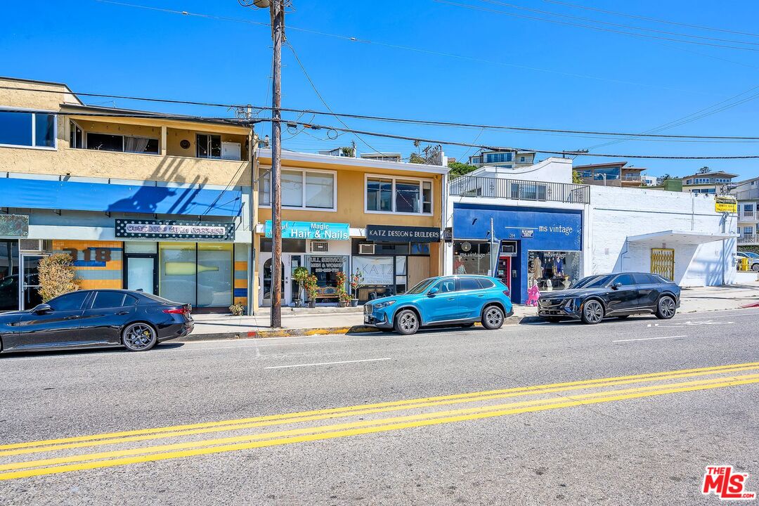 a view of a cars park in front of a building