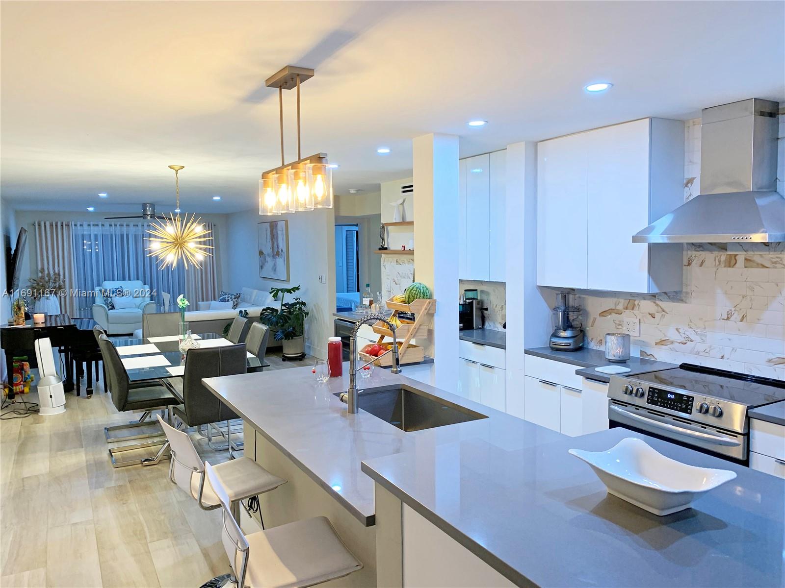 an open kitchen with dining table and chairs