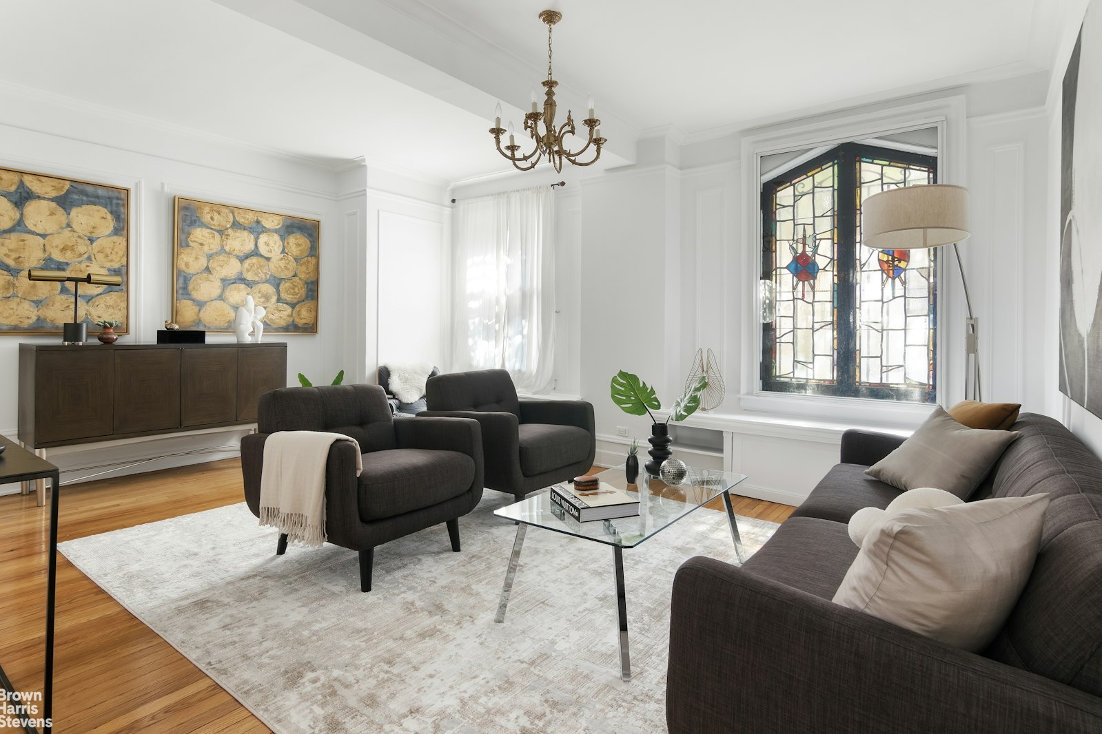 a living room with furniture a flat screen tv and a large window