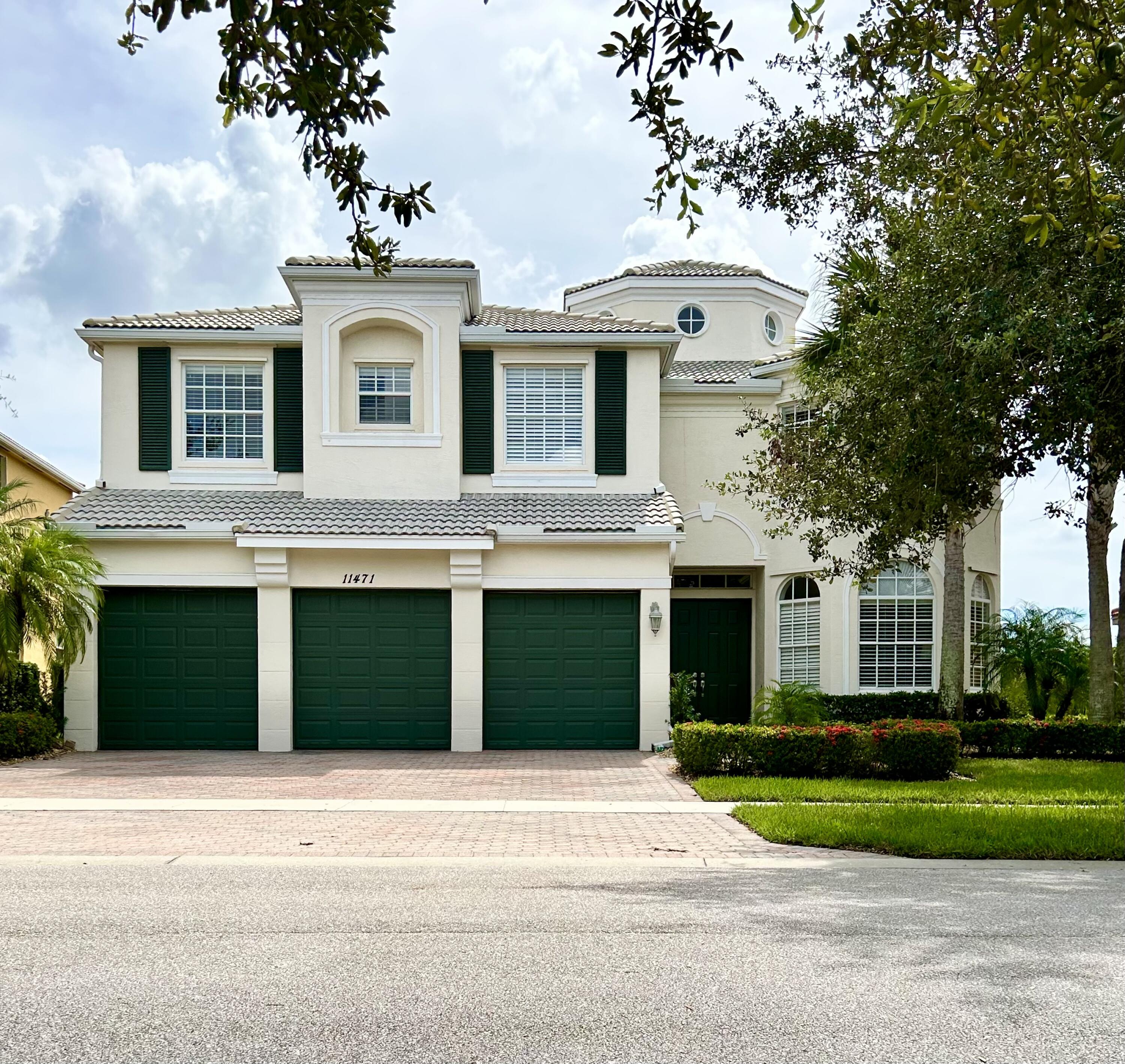 a front view of a house with a yard and a garage