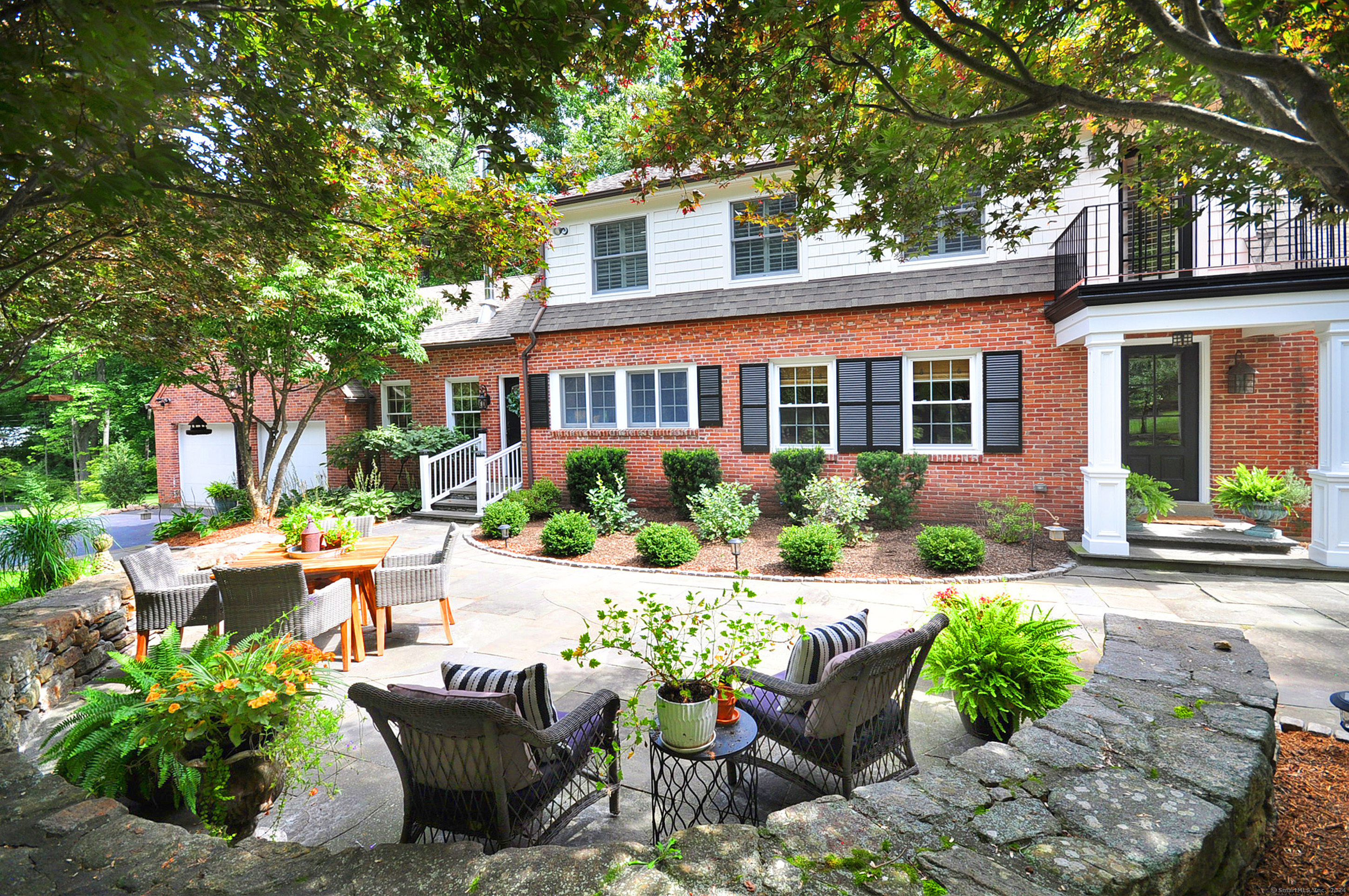 a view of a house with backyard sitting area and garden