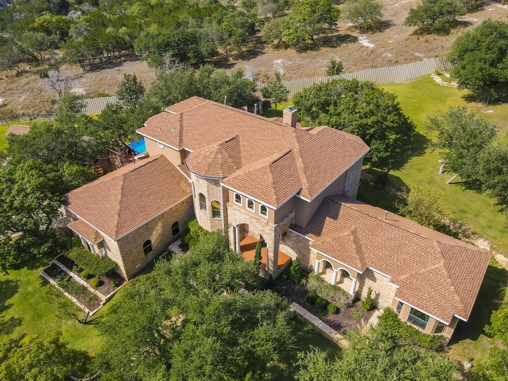 an aerial view of a house with yard