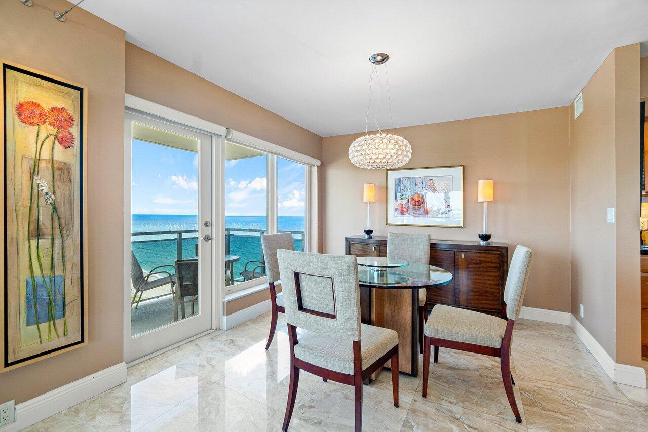 a dining room with furniture a rug and a large window