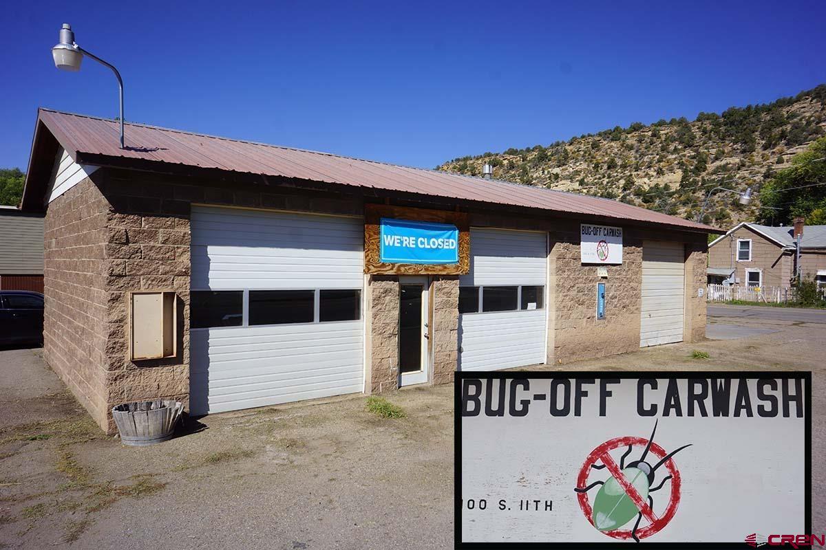 a front view of a house with a sign board