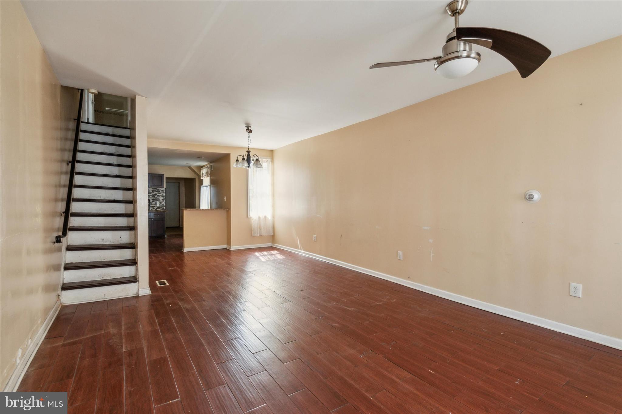 a view of empty room with wooden floor