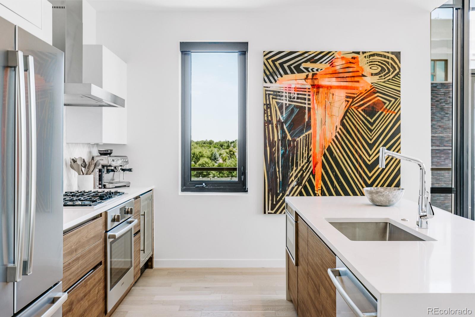 a kitchen with stainless steel appliances granite countertop a sink and a stove