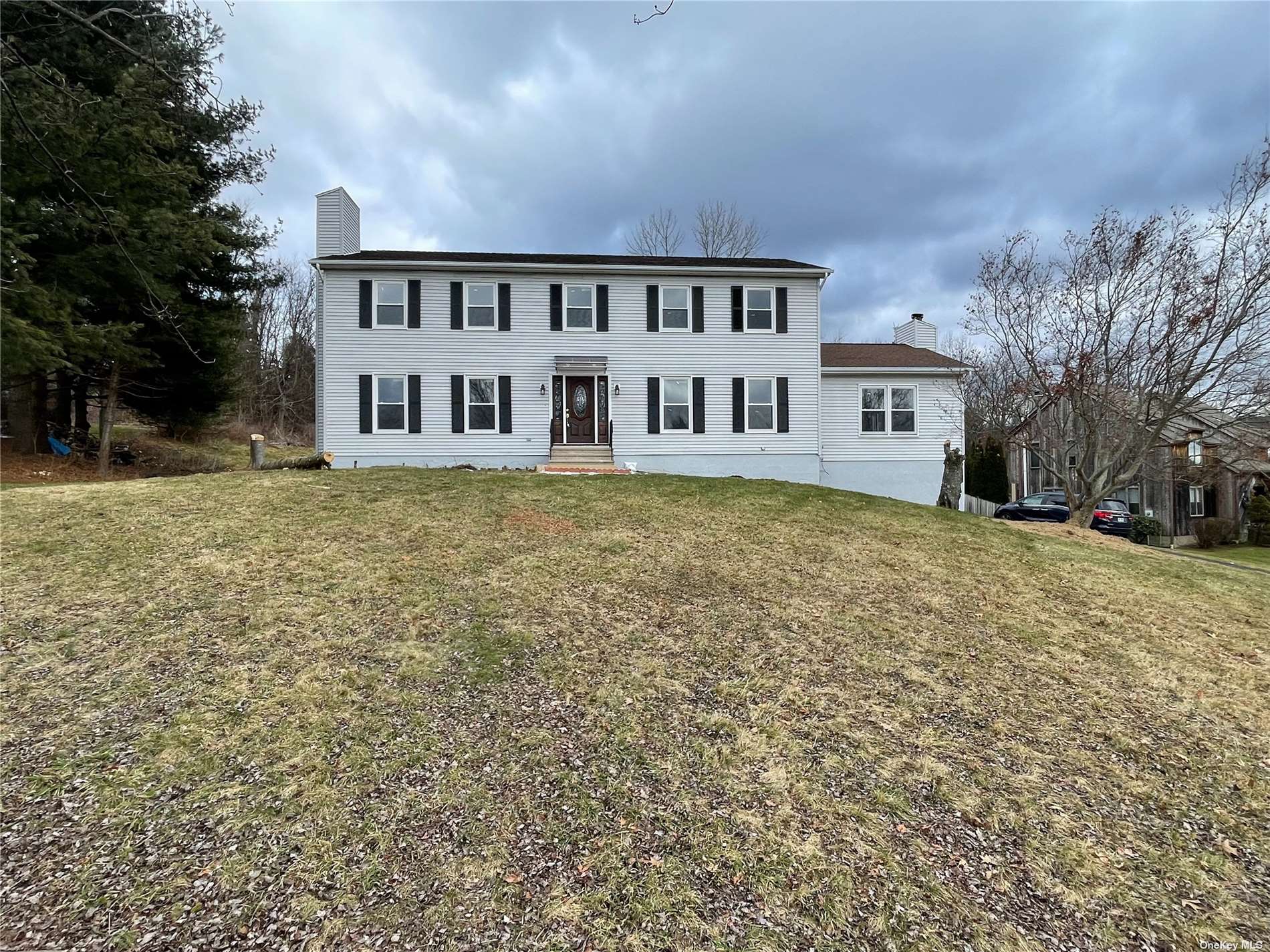 a view of a house with backyard and sitting area