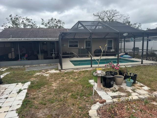 a view of a house with backyard porch and sitting area