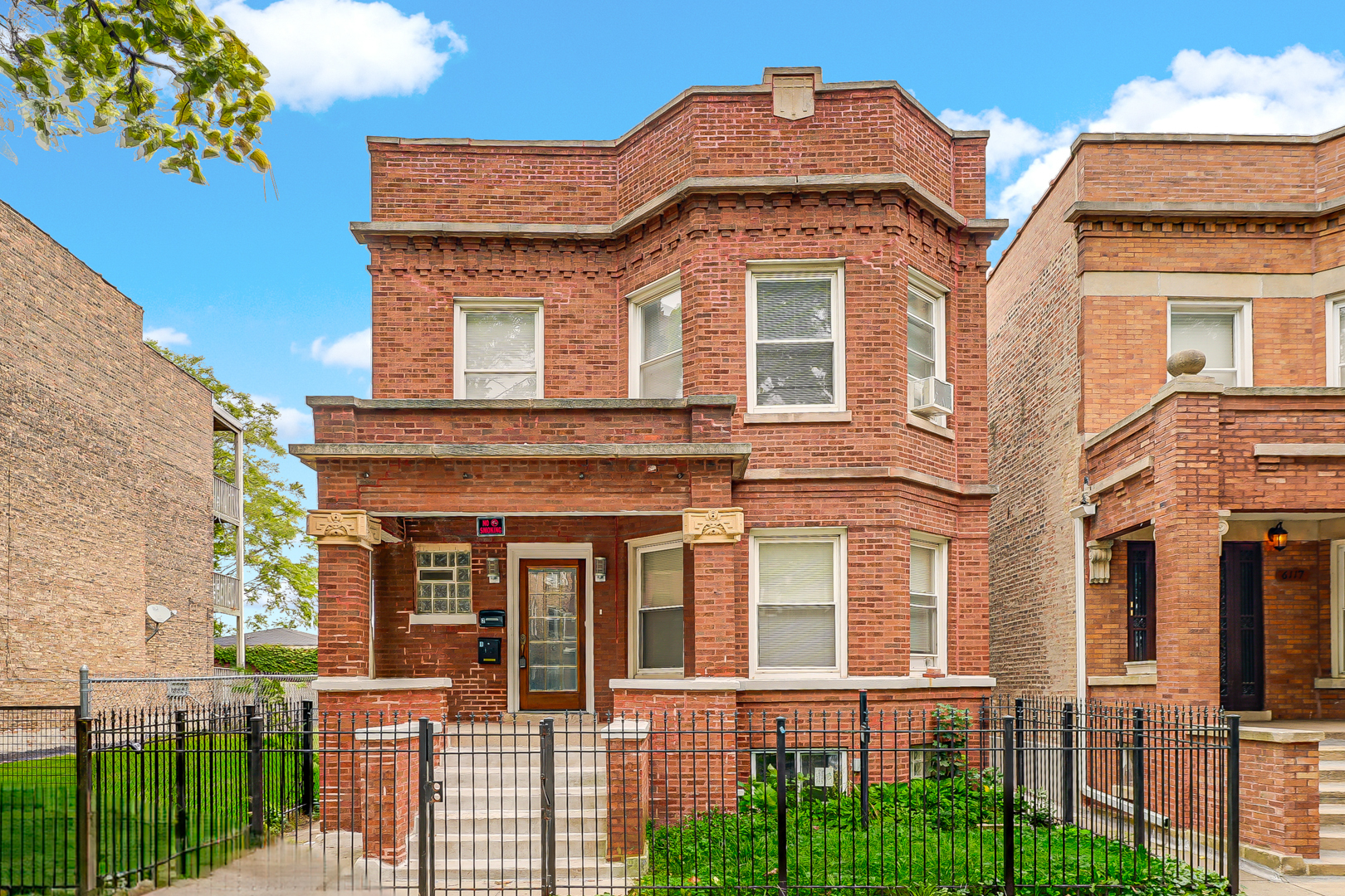 front view of a brick house with a large windows