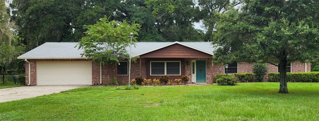 a front view of a house with a garden and yard