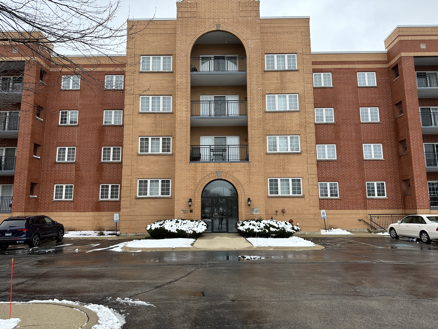 a front view of a building with parking space