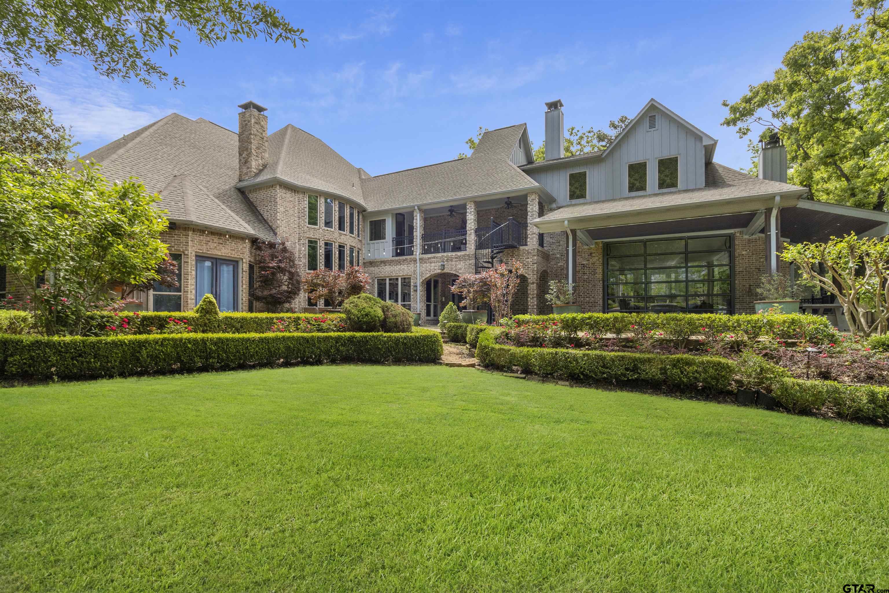 a front view of house with yard and green space