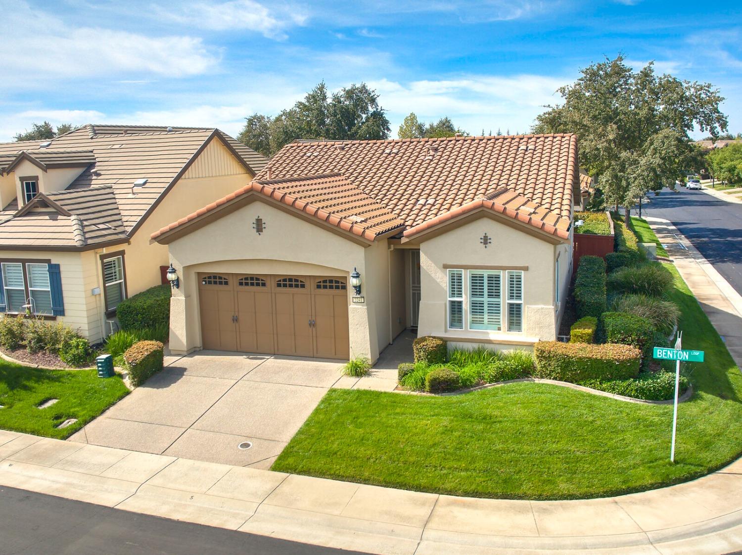 a front view of a house with a garden