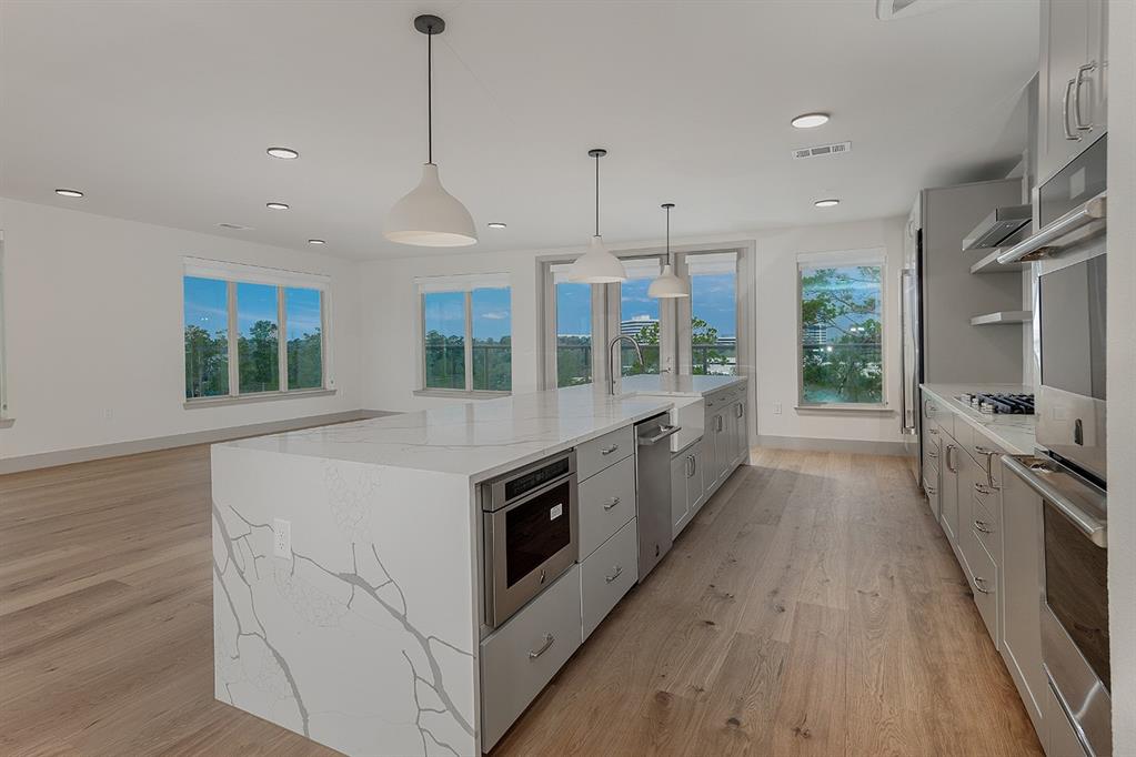 an open kitchen with a stove and a sink