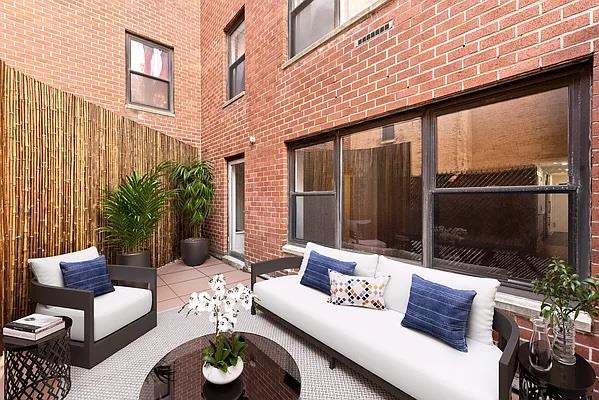 a outdoor living space with furniture and a potted plant