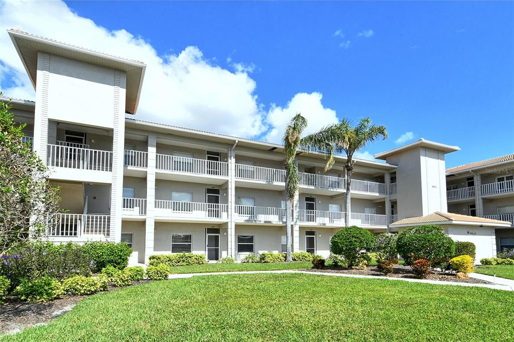 a front view of a building with a garden