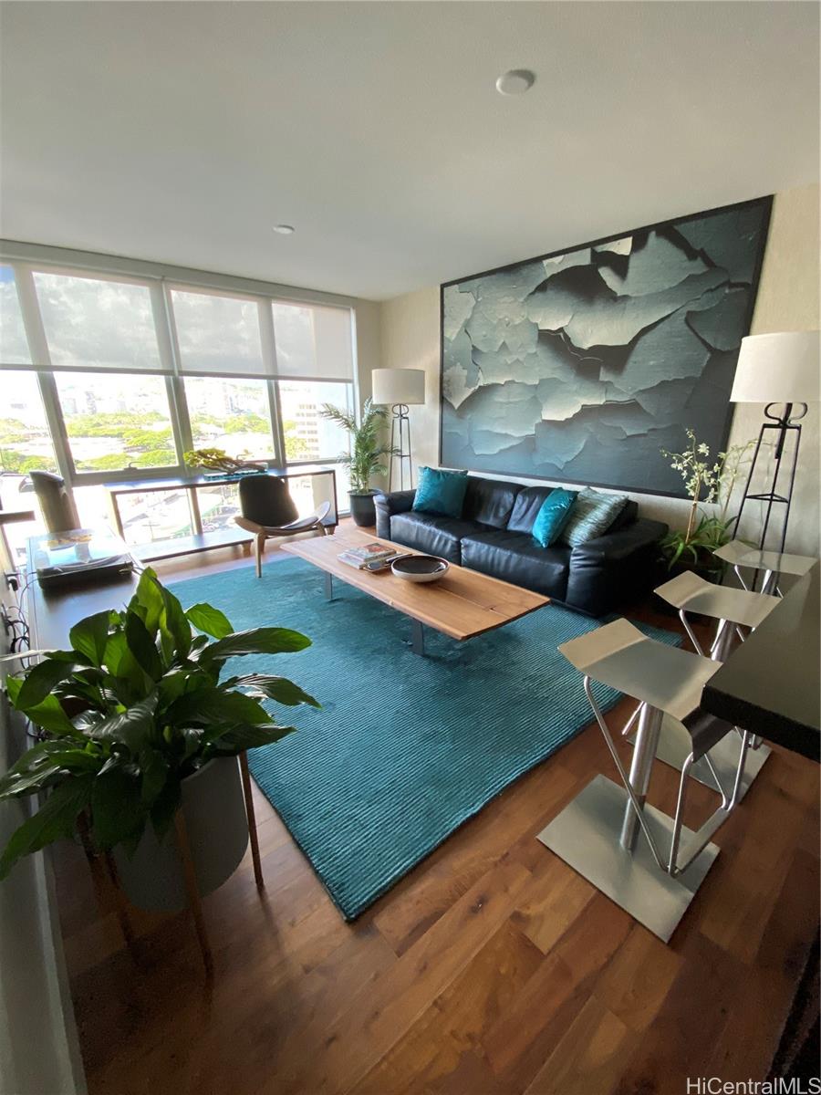 a living room with dining table and a large window