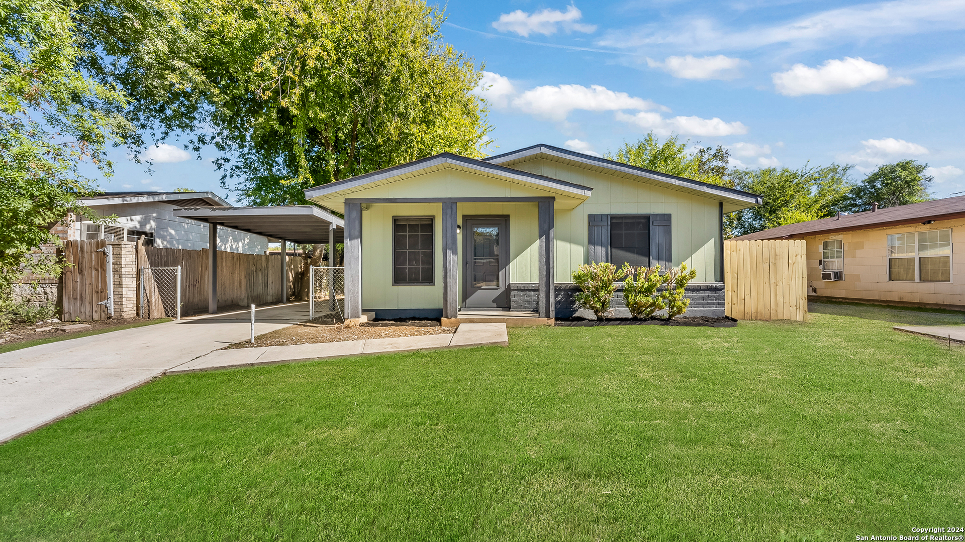 a view of a house with a yard and sitting area