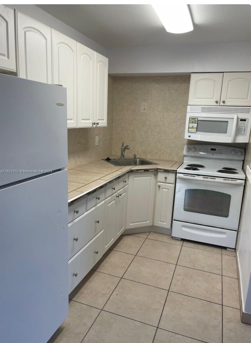 a kitchen with cabinets and appliances