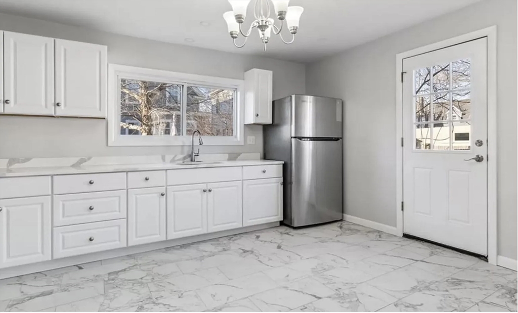 a kitchen with stainless steel appliances a refrigerator sink and cabinets