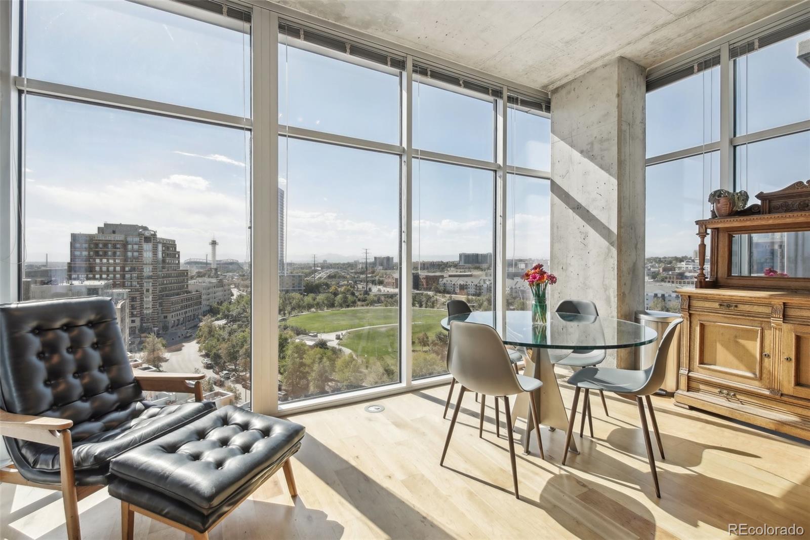 a living room with furniture and a floor to ceiling window