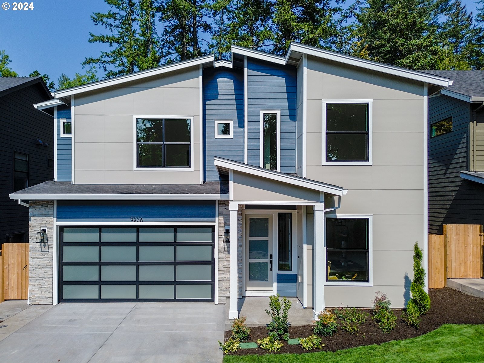 a front view of a house with a yard and garage