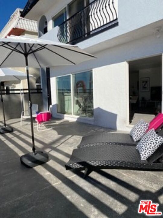 a view of a patio with table and chairs potted plants