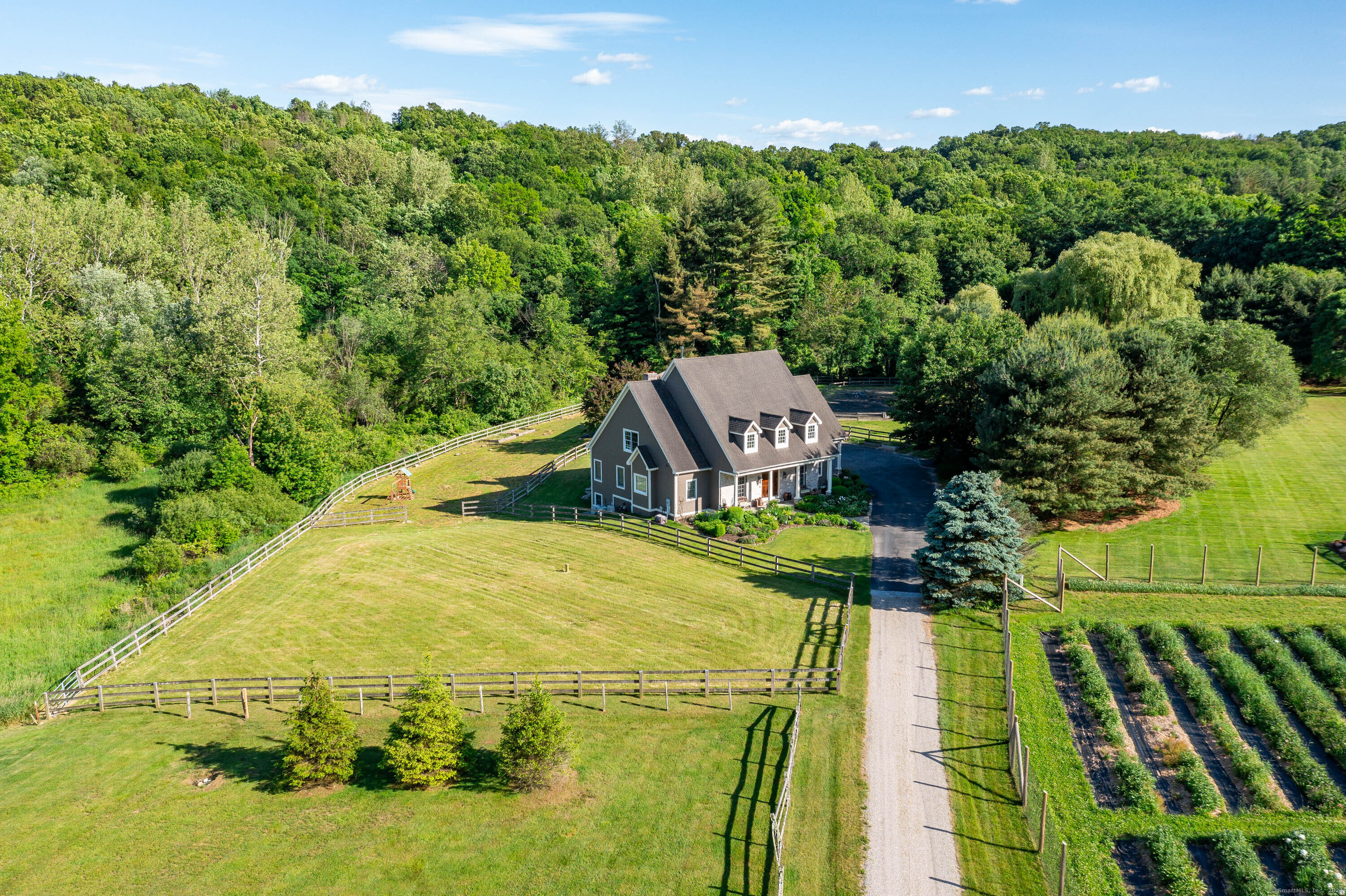 Welcome to 51 Pond Brook Road, a stunning 3.67 acre horse property with a barn, riding ring, and paddocks bordering the peaceful Pond Brook