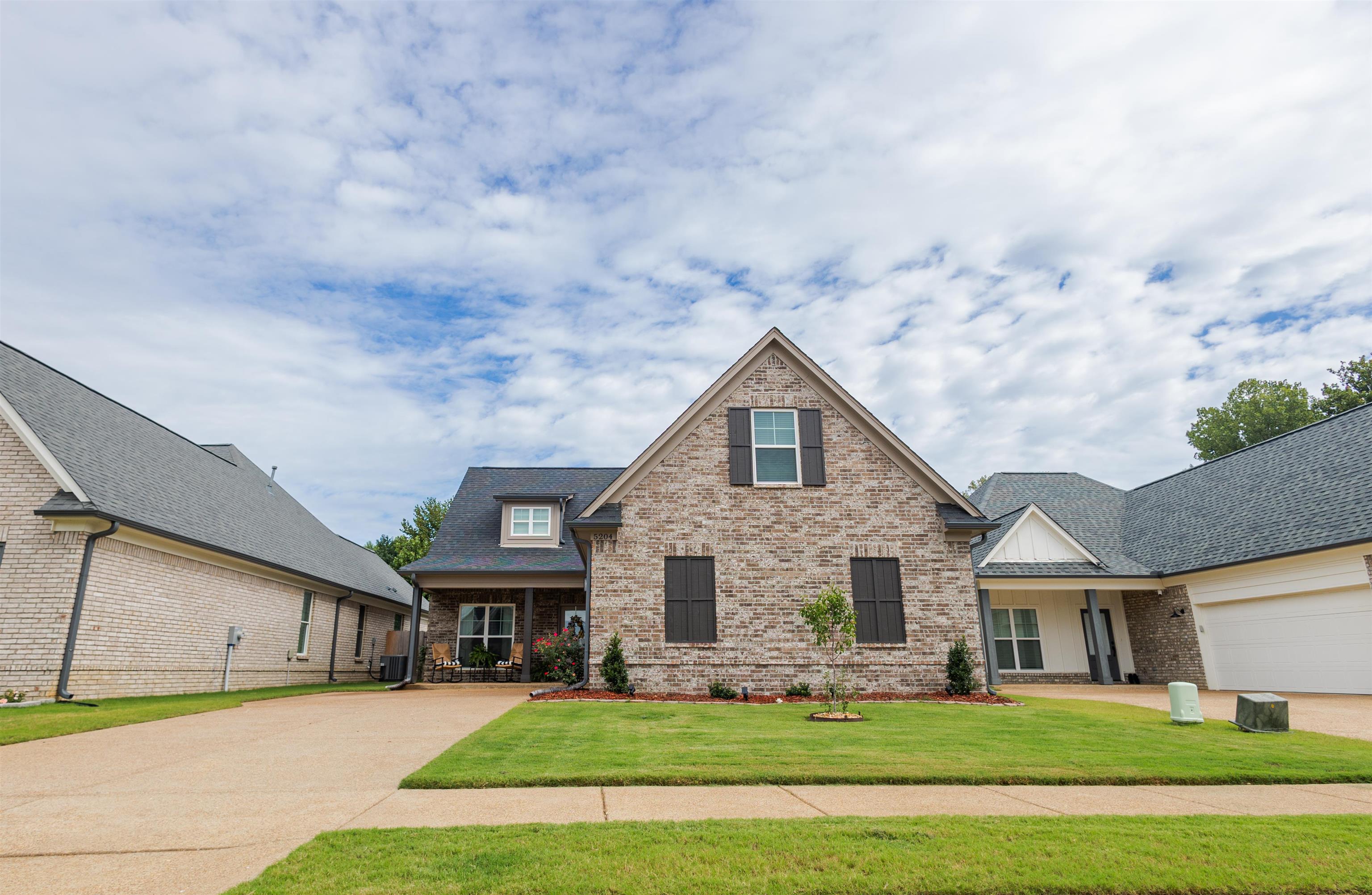 a view of house with yard in front of it