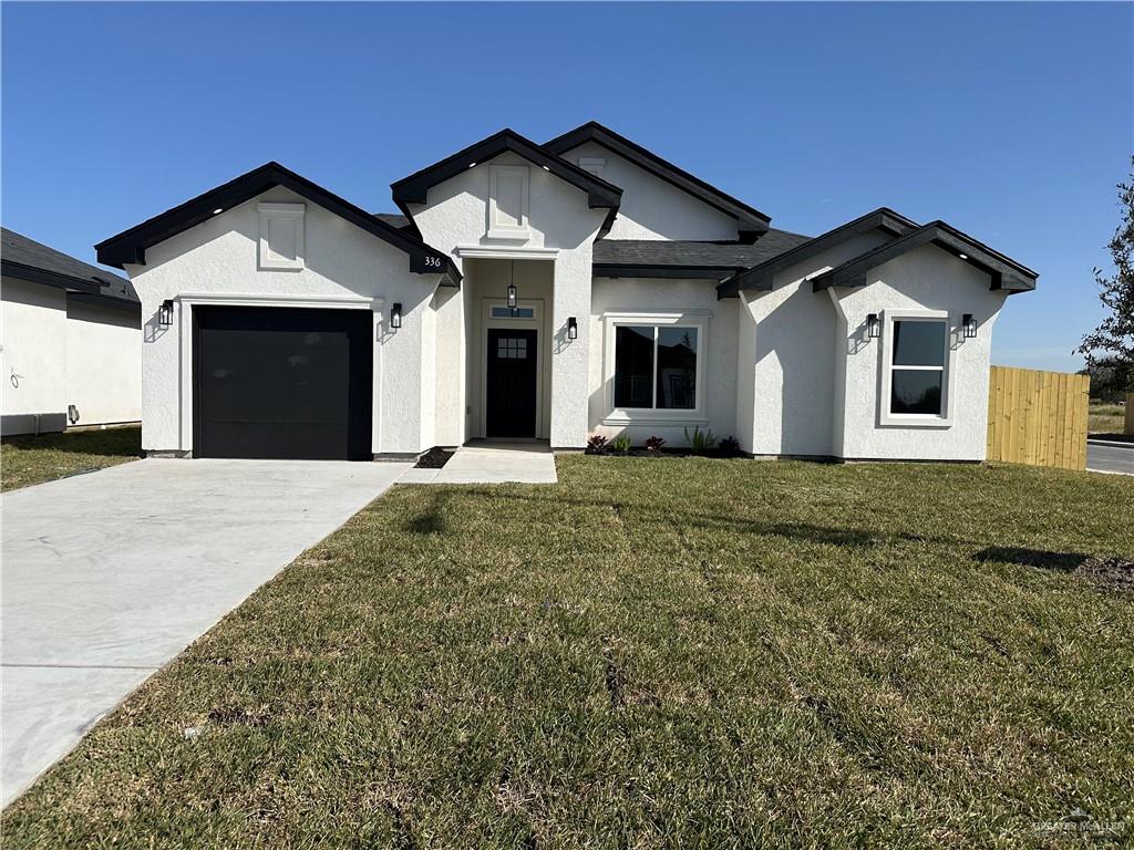 a front view of a house with a yard and garage