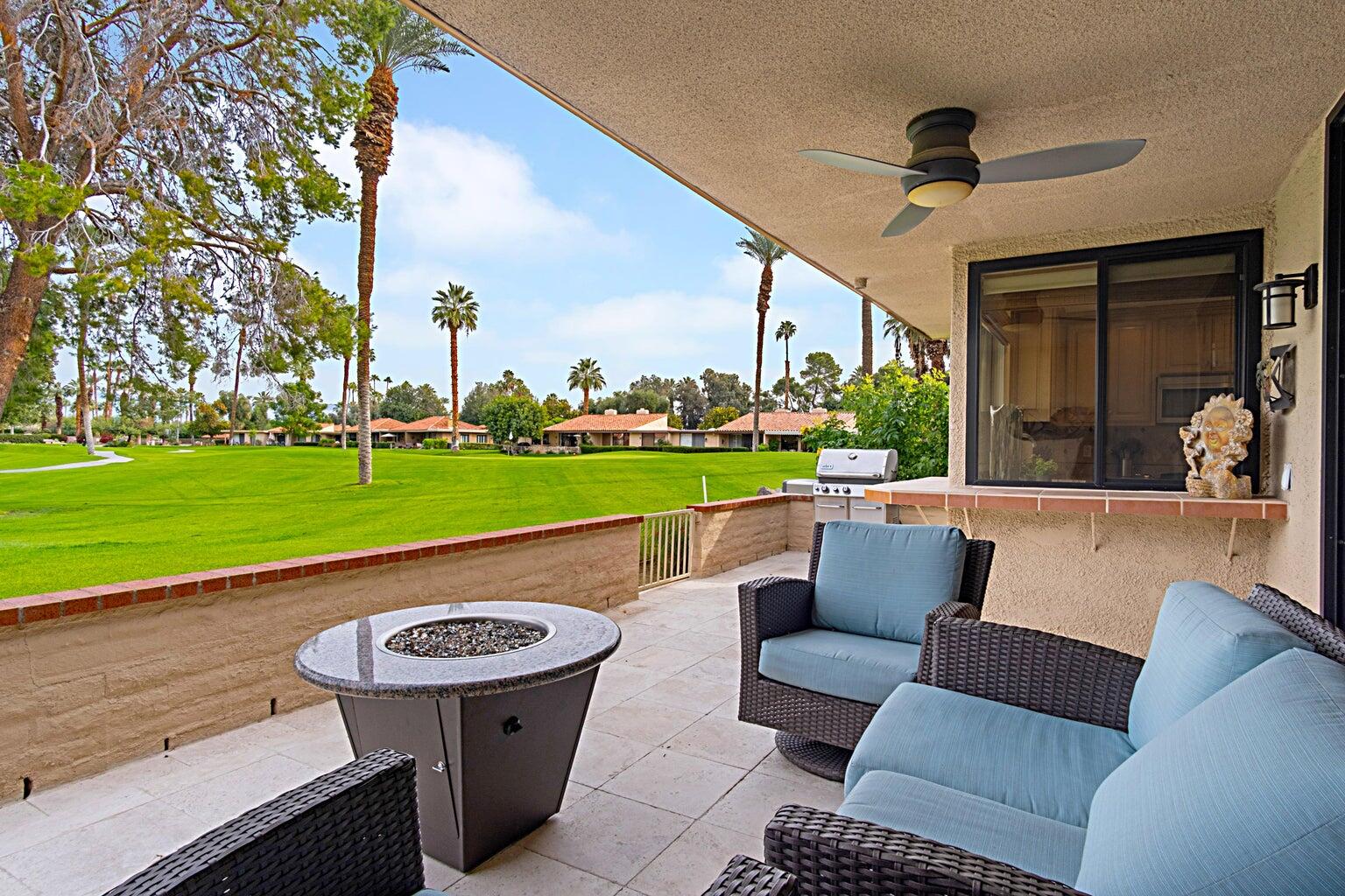 a view of swimming pool with a couches in a patio