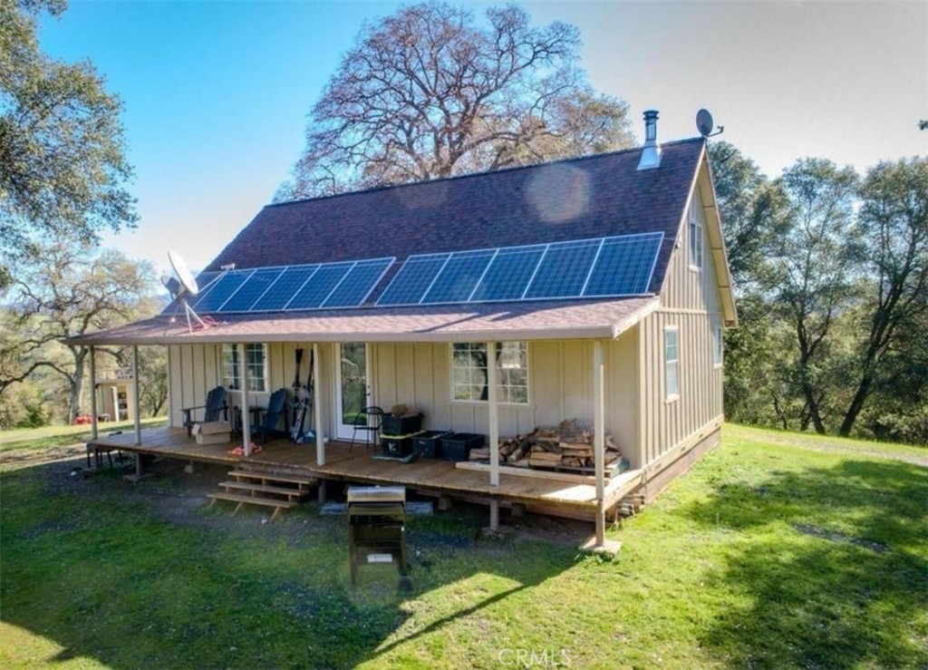 a backyard of a house with table and chairs