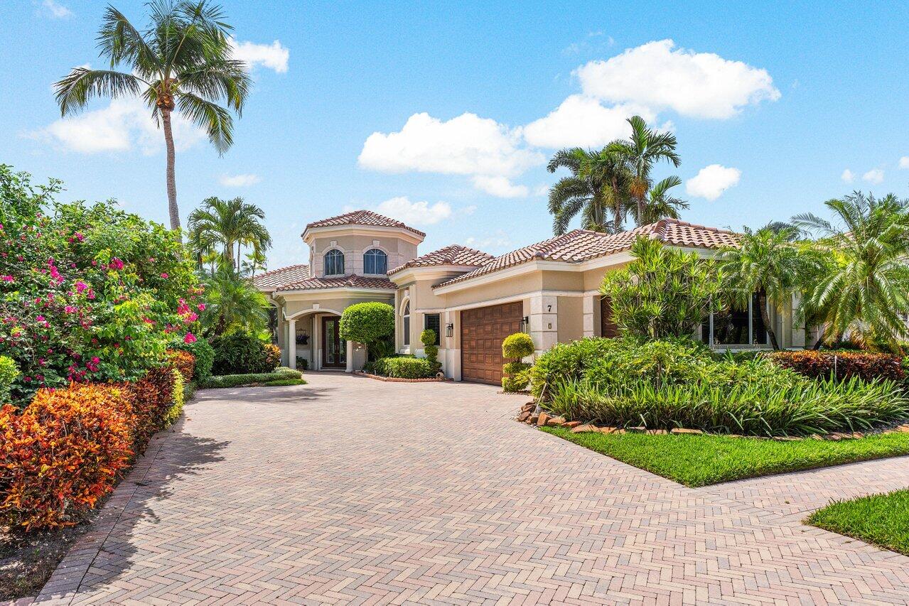 a front view of a house with a garden and a yard