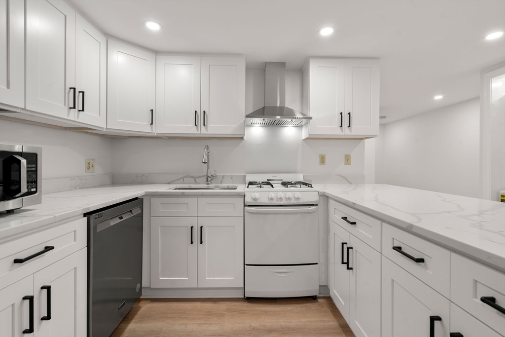 a kitchen with cabinets appliances and a sink