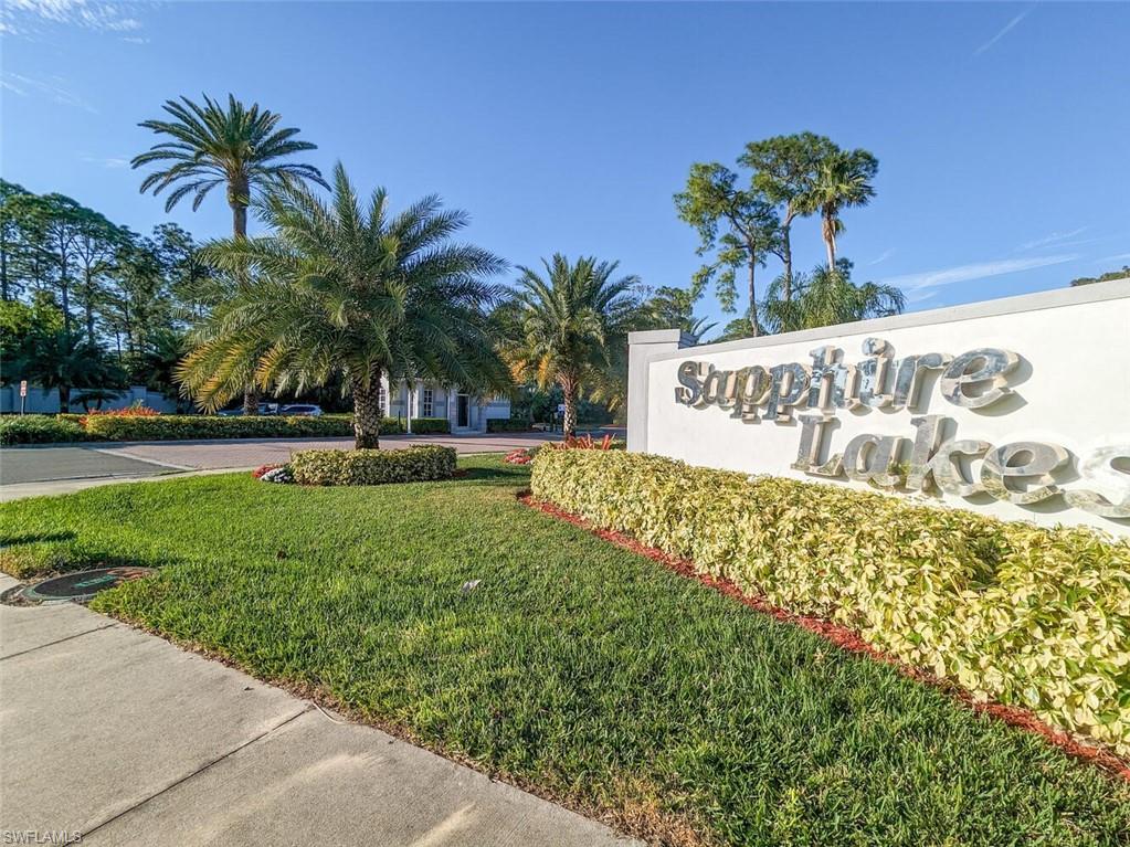 a view of a sign board with palm trees