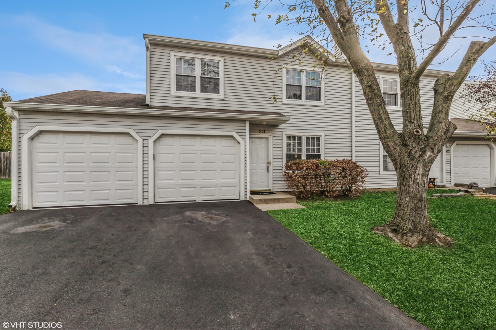 a view of a house with a yard and garage