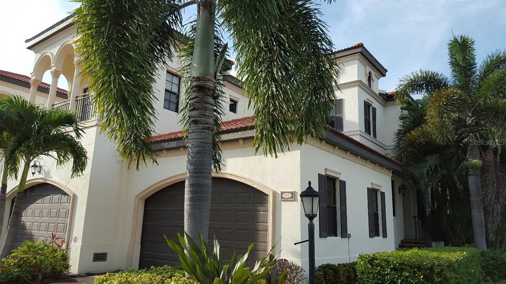 a view of a house with a palm tree