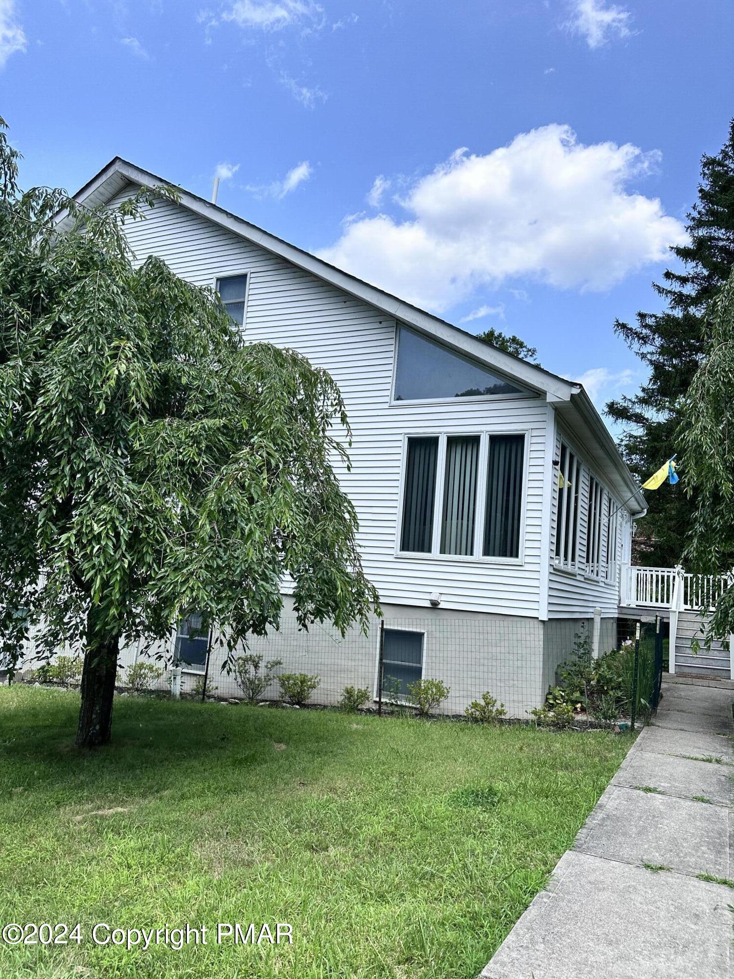 a front view of a house with a garden