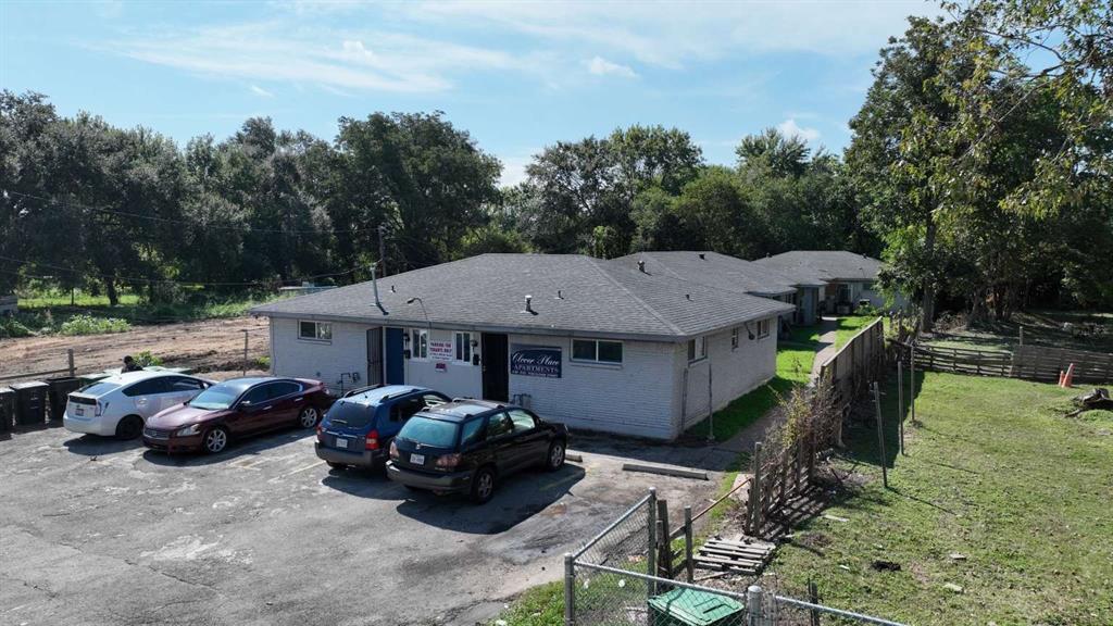 a front view of a house with cars parked