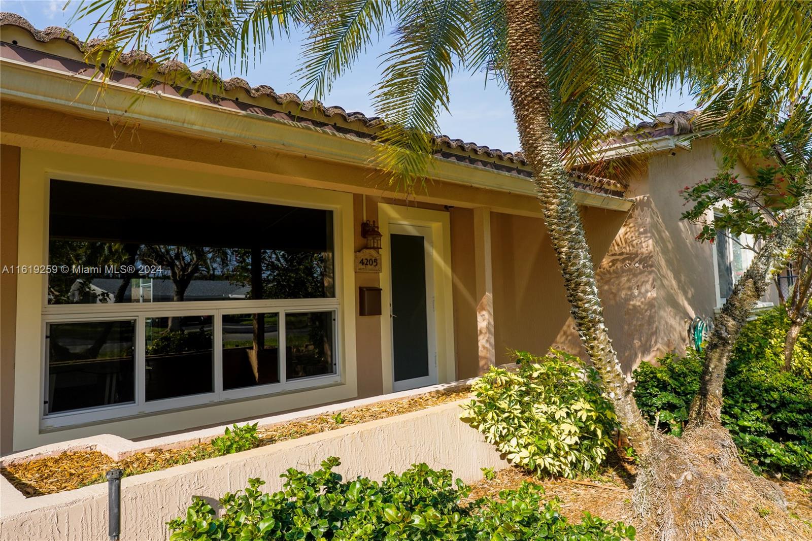 front view of a house with a potted plant