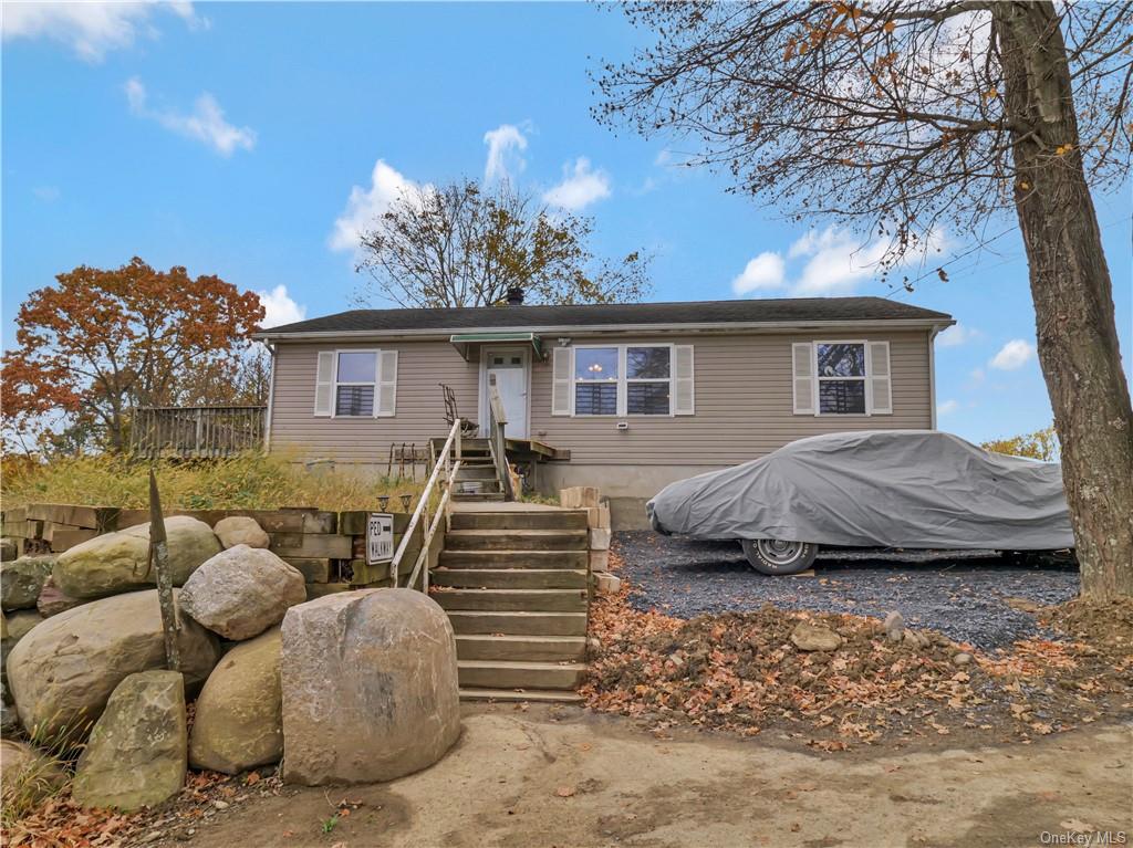 a view of a house with a couches and a fire pit