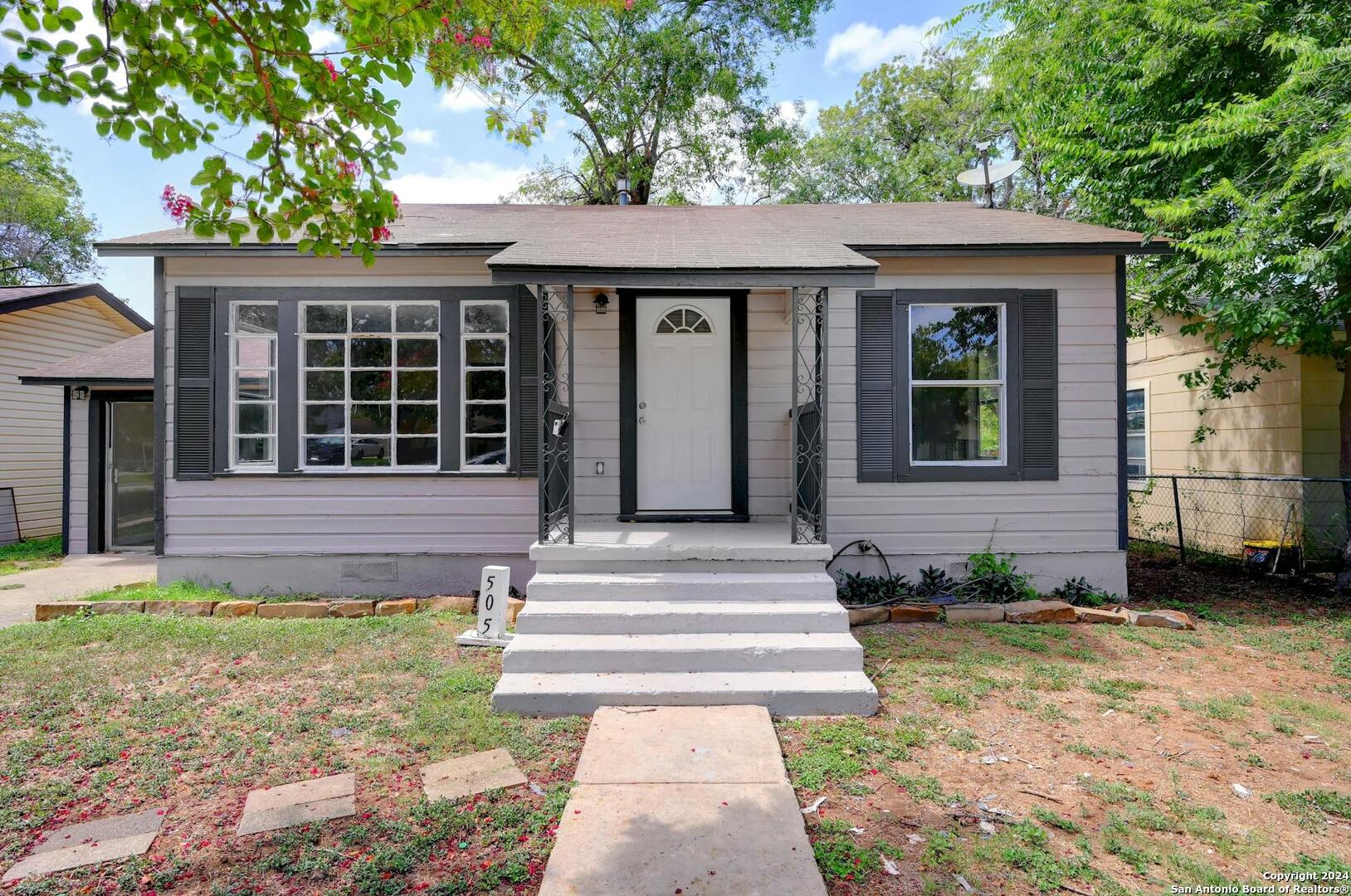 a front view of a house with a garden