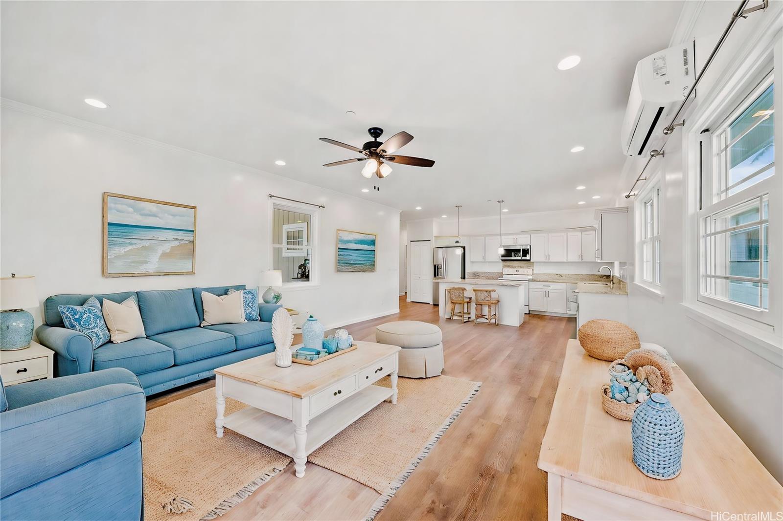 a living room with furniture kitchen and a table