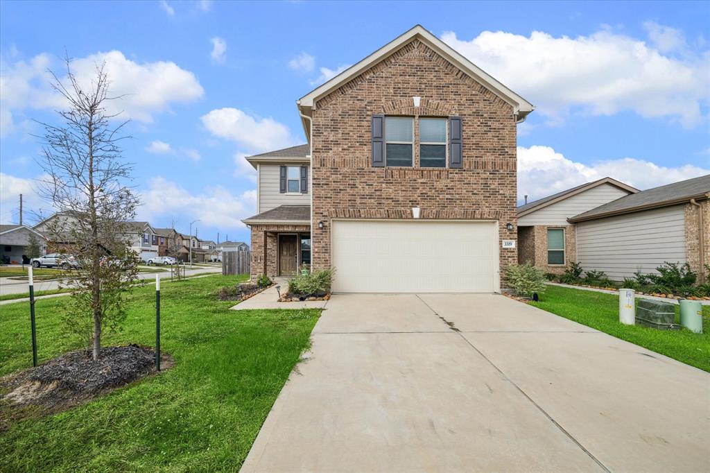 This charming two-story home, situated on a prominent corner lot, boasts a classic Craftsman architectural style.